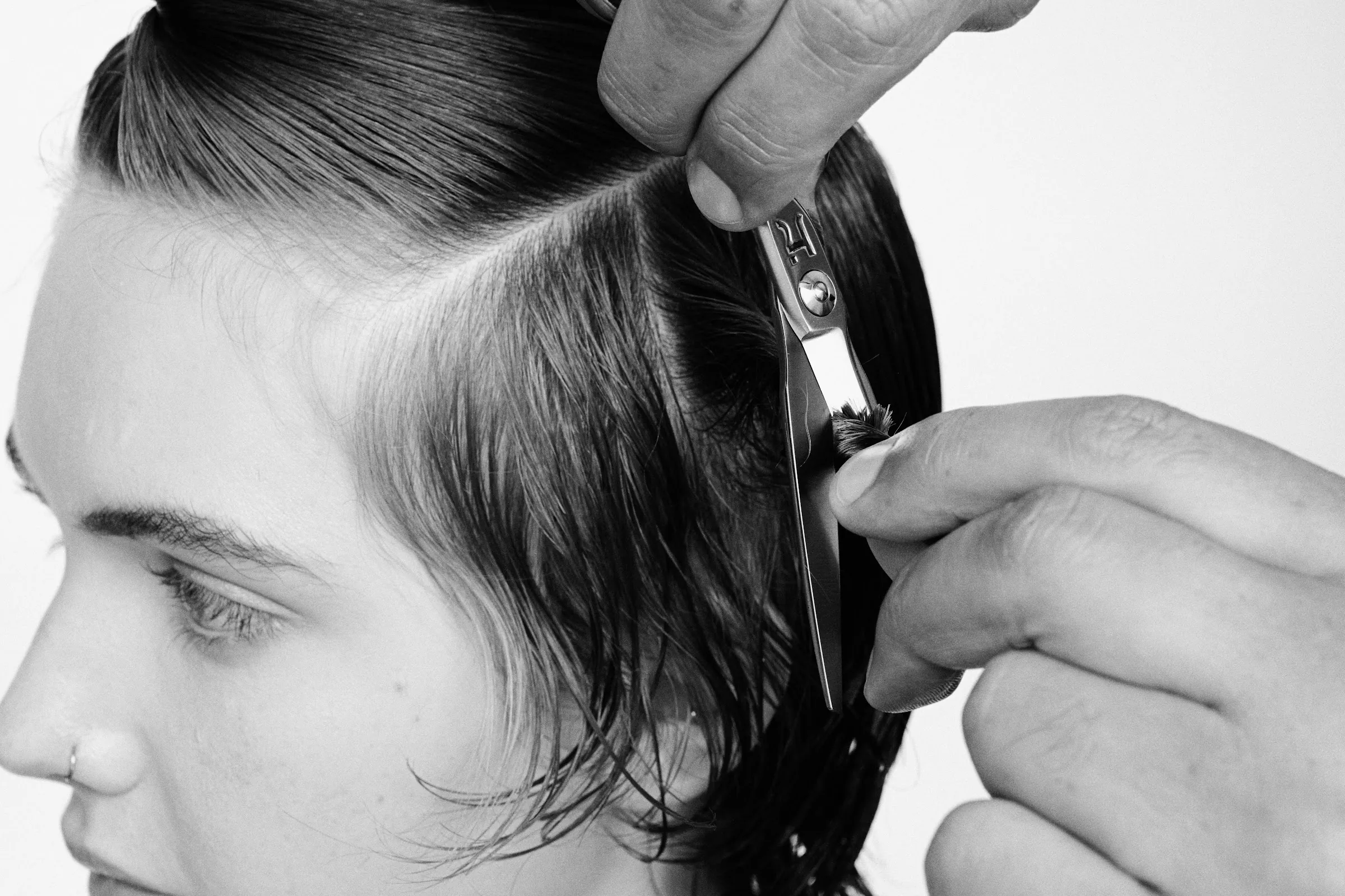 Stylist cutting hair with a Hanzo shear