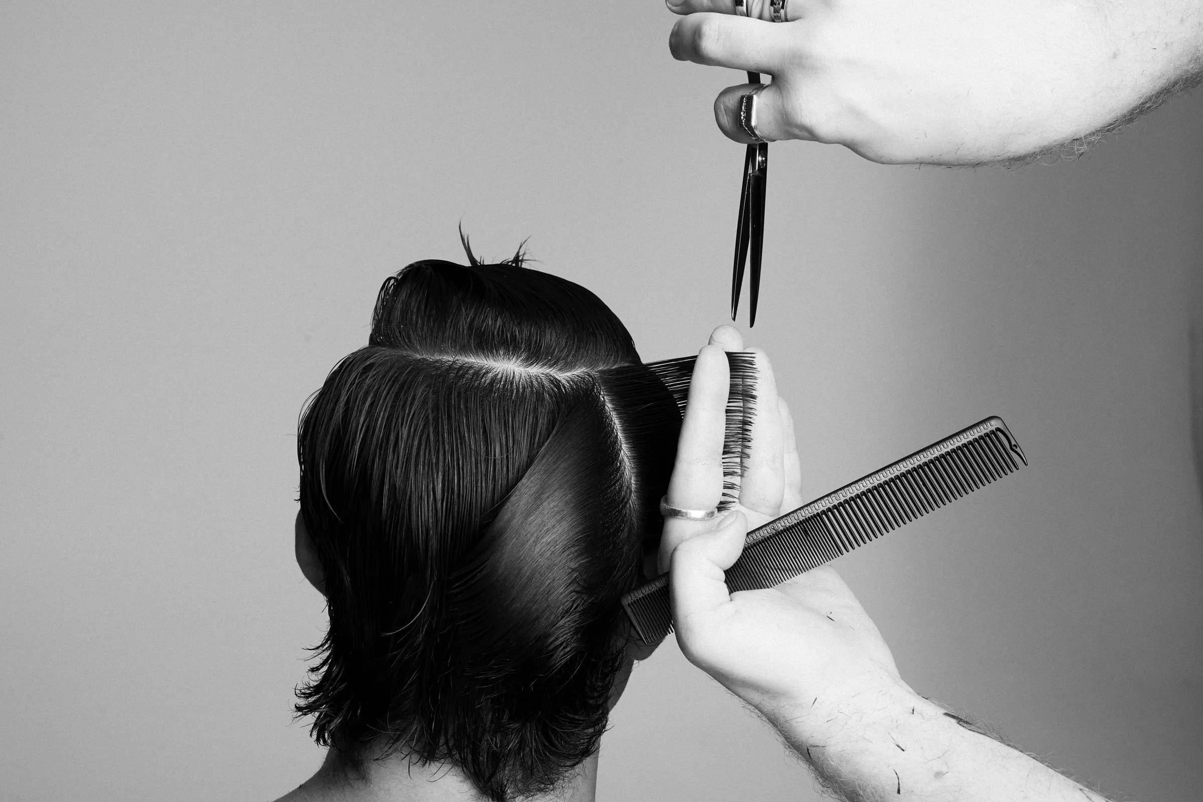 Stylist cutting hair with a Hanzo shear
