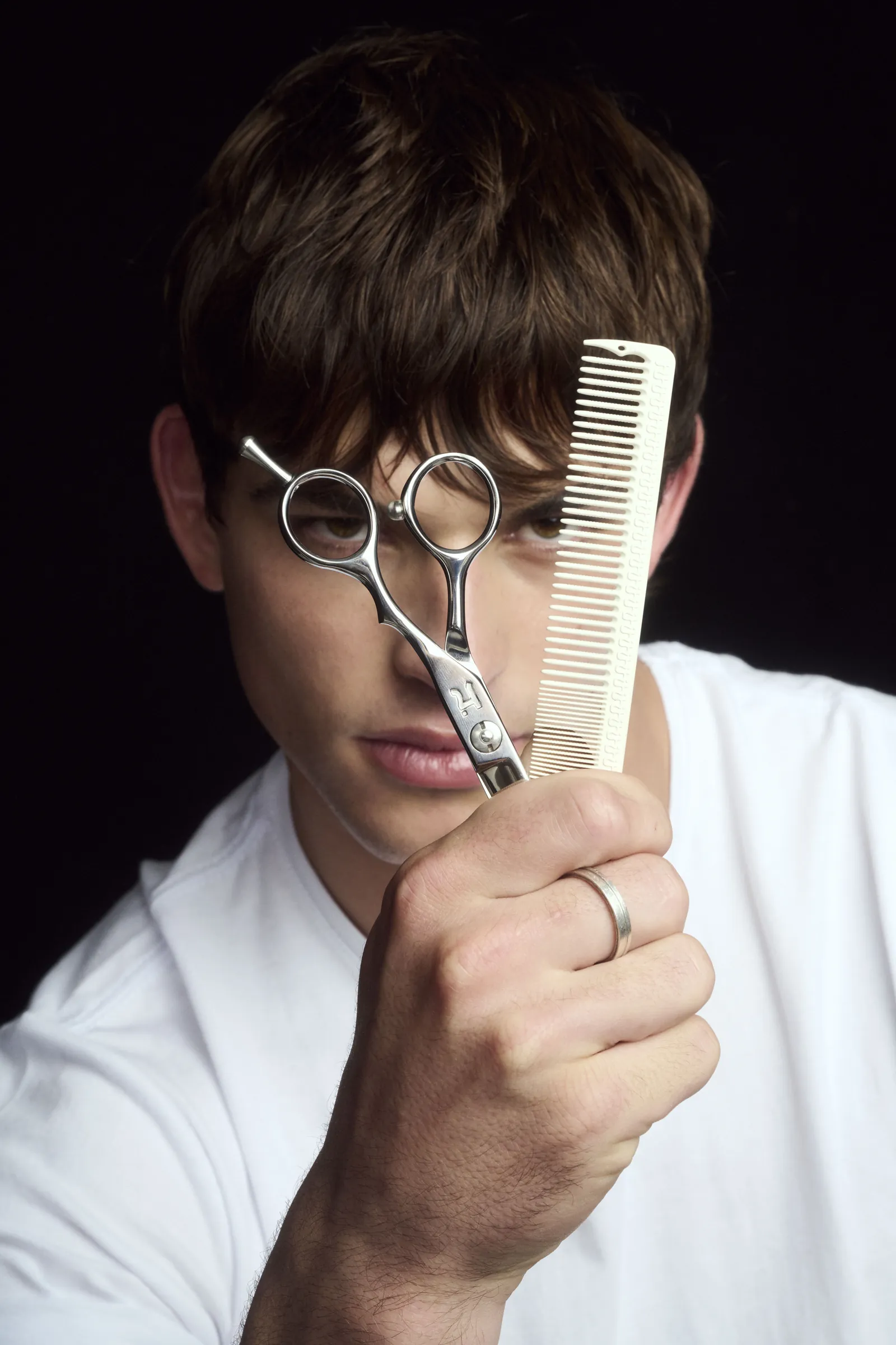 Model holding a Hanzo shear and comb