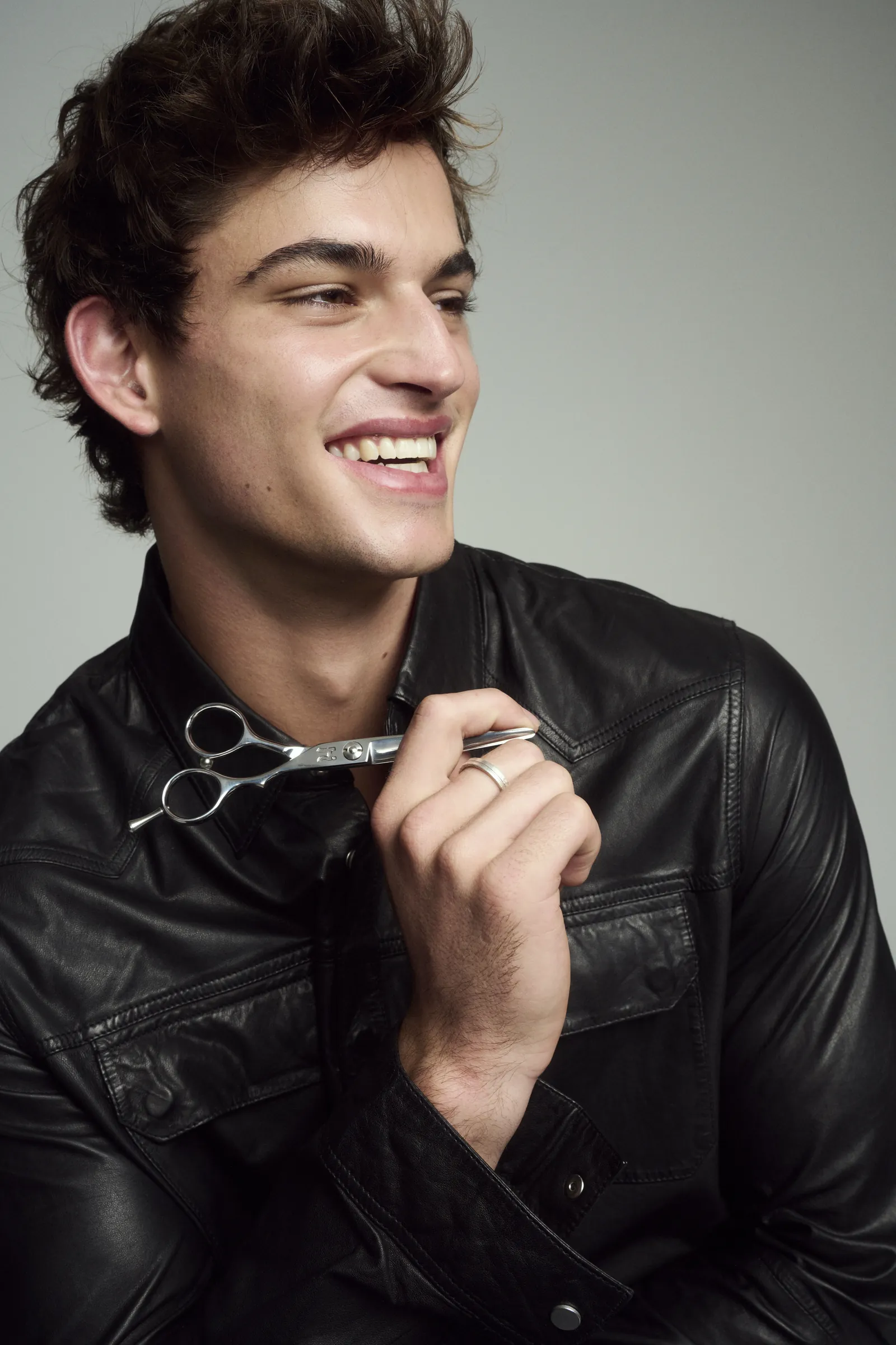Smiling model holding Hanzo shears