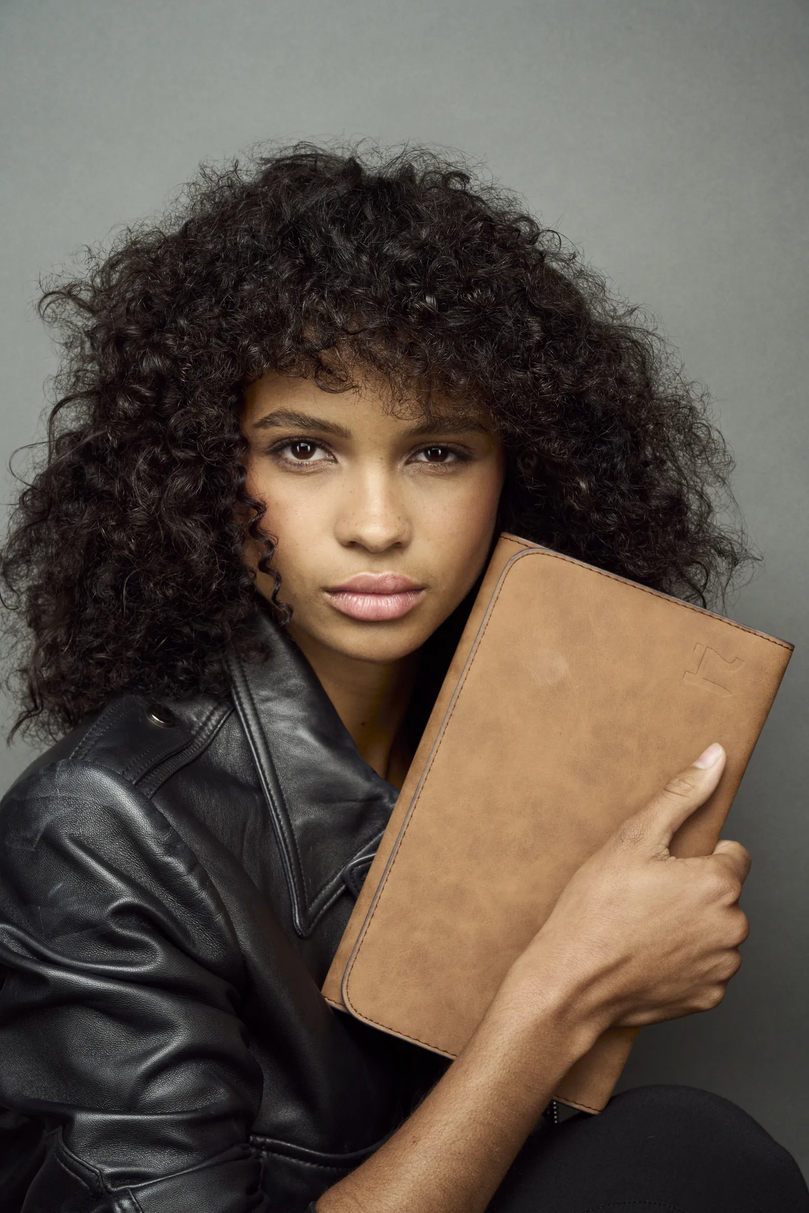 Smiling model holding a notebook