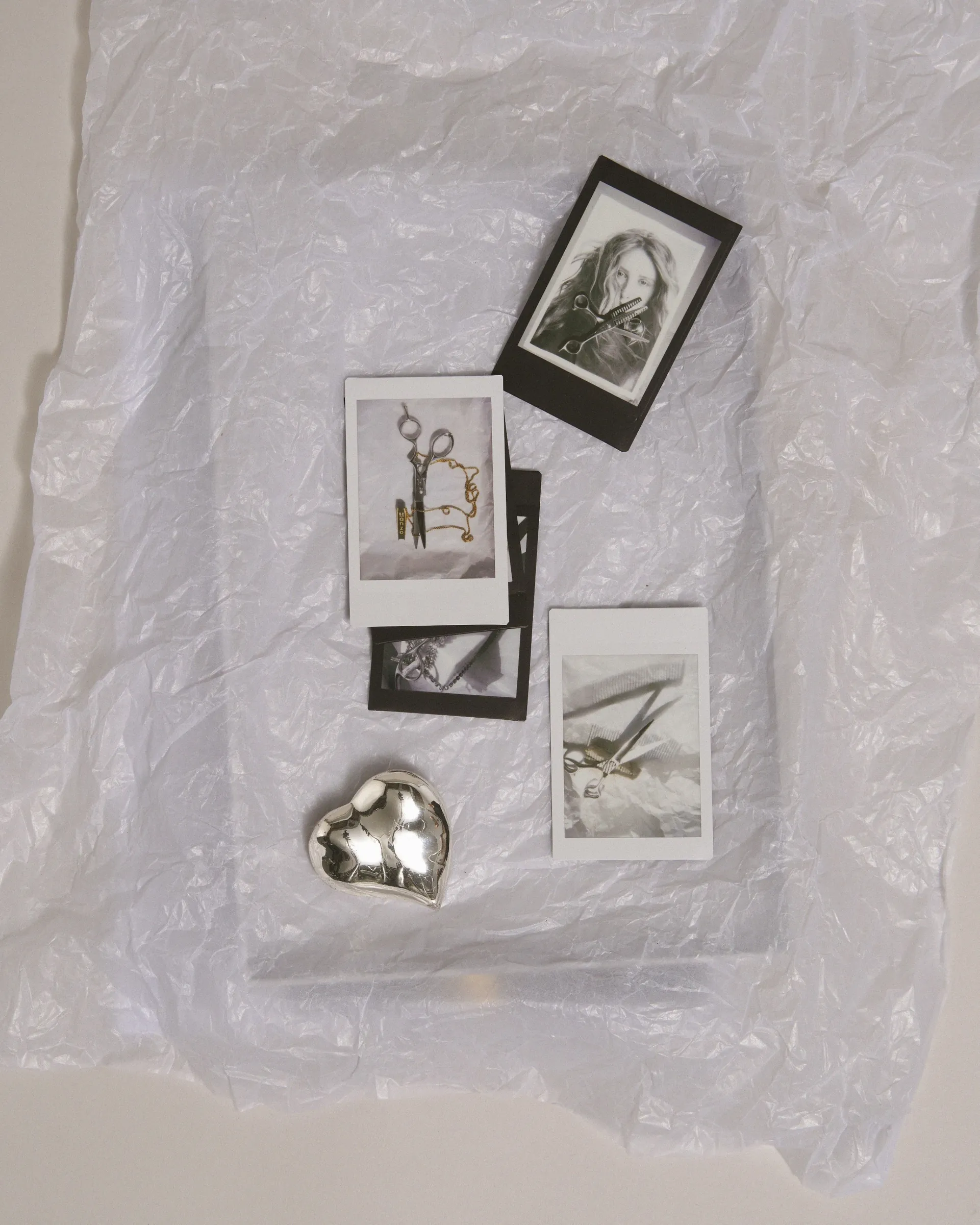 Polaroids, prints and a Hanzo shear laid out